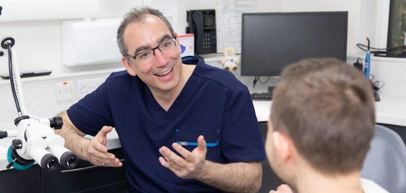 Dr Glafcos Tombolis in a consultation with a patient
